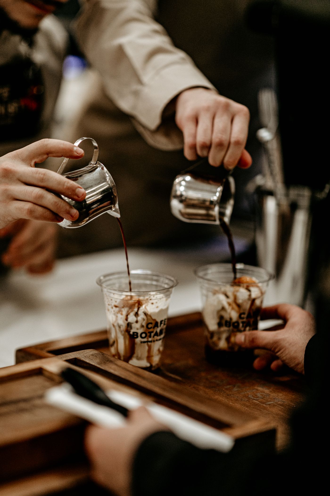 Baristas preparing drinks at a branded pop-up counter